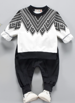 Two piece toddler boy sweatsuit. Long sleeve black and white designed top with black comfy pants with an elastic waist. 
