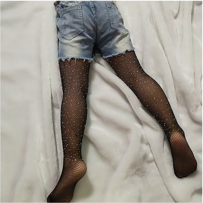 Add a little glitz and glam to your outfit with these adorable rhinestone tights. These fishnet style tights have different sized rhinestone's cascading up and down. Can fit child up to 5ft!  Available in black and brown! Boujie Kidz