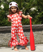 Red bell bottom romper with baseball pattern. Red ribbon is tied into a bow located at the ankle.